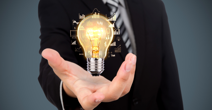 Startup Idea lit up like a bulb in a man’s hand